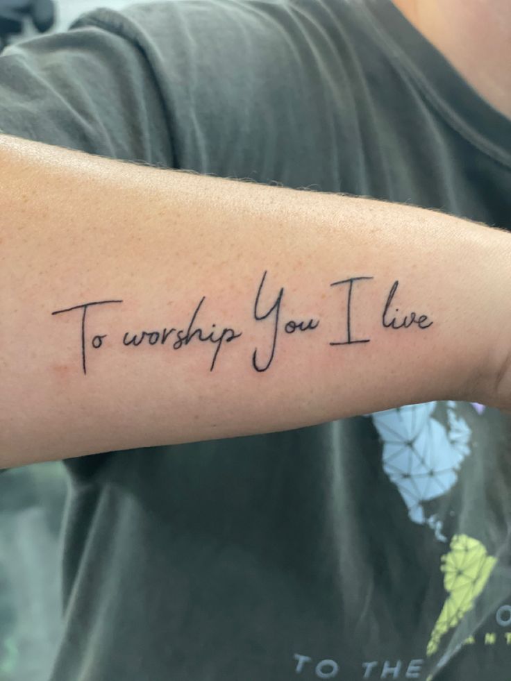 a man's arm with the words to worship you i live written on it