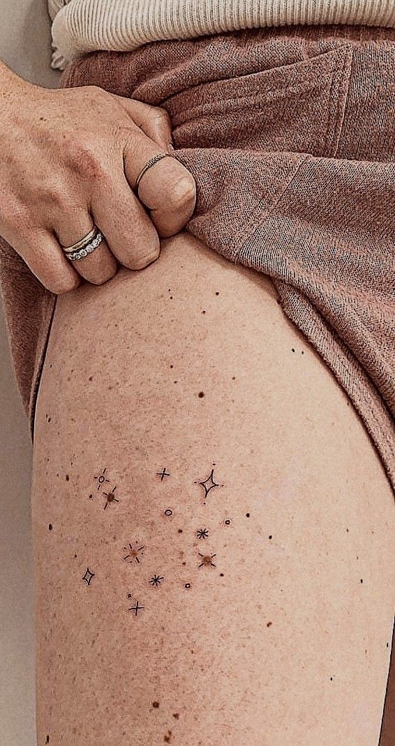 a woman's thigh with small stars on it