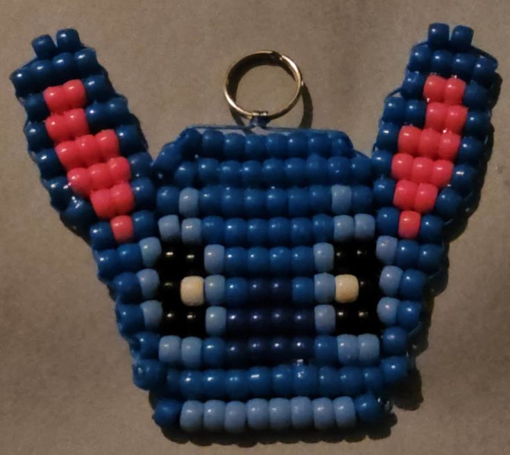 a blue and red beaded keychain hanging from a hook