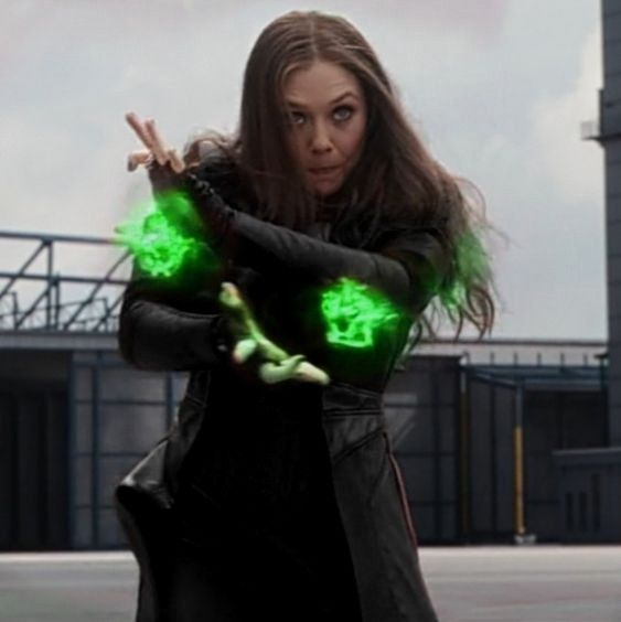 a woman dressed in black holding green lights