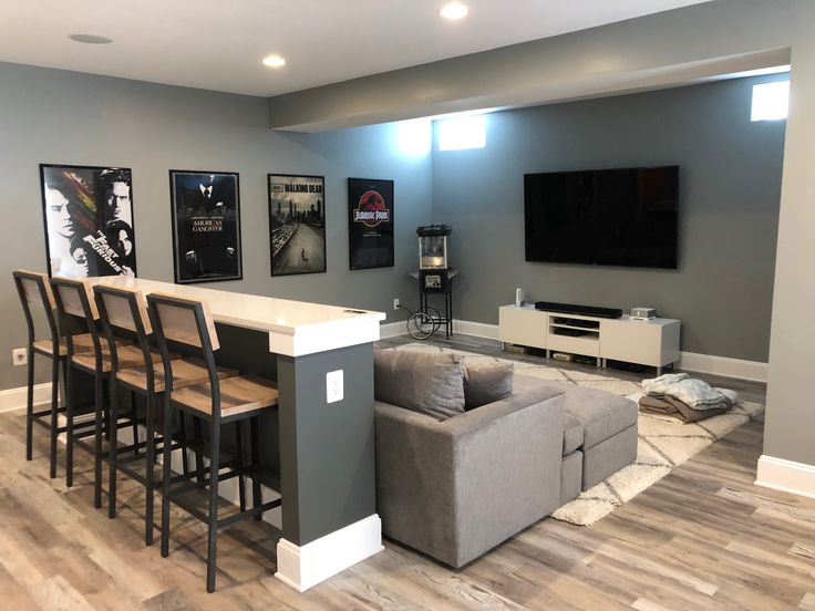 a living room filled with furniture and a flat screen tv mounted to the side of a wall