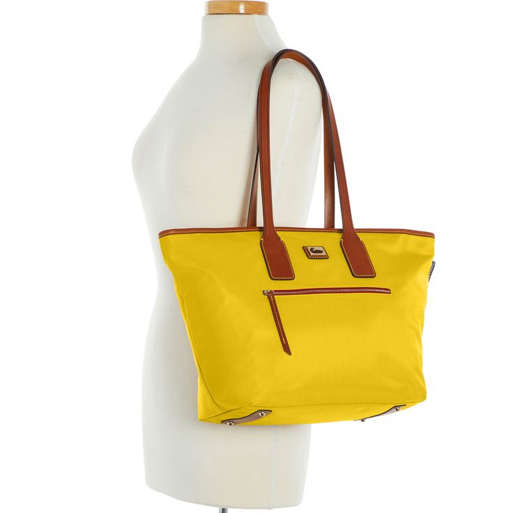 Sporty and Classic    This sporty classic holds everything you need for the morning commute or extra clothes for a trip to the gym. All-weather nylon, Vacchetta leather trim, and heritage details exude signature all-American style. Sporty Yellow Bags For Travel, Sporty Yellow Travel Bag, Classic Nylon Shoulder Bag For Shopping, Casual Nylon Bag With Leather Trim, Yellow Waterproof Travel Bag, Yellow Coated Canvas Shoulder Bag For Travel, Waterproof Leather Shoulder Bag For Travel, Yellow Coated Canvas Bag For Travel, Yellow Coated Canvas Bags For Travel