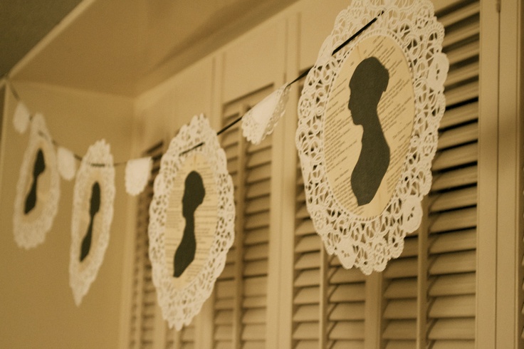 some paper doily hanging from the side of a wall next to shutters and windows