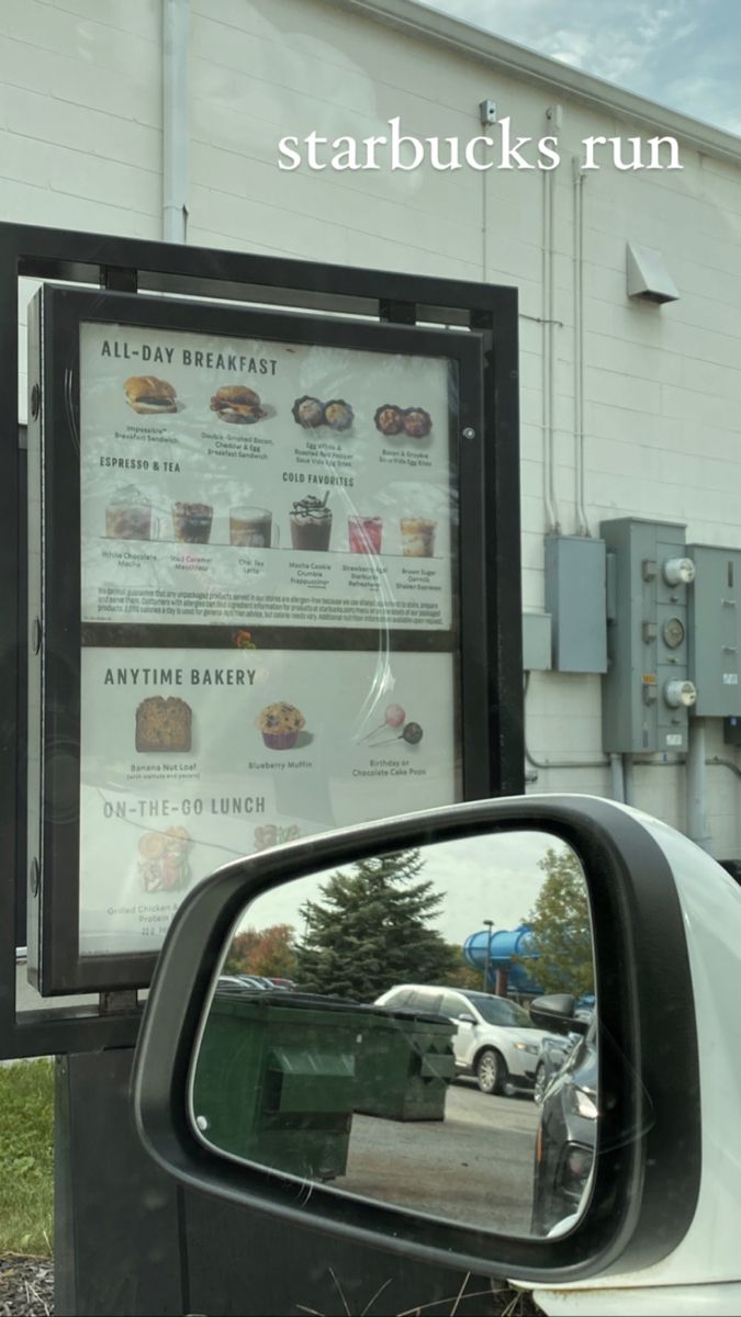 the side view mirror of a car is shown in front of a starbucks run sign