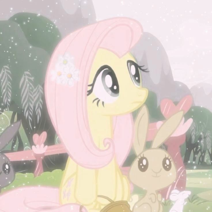 a little pony sitting on top of a grass covered field next to a bunny rabbit