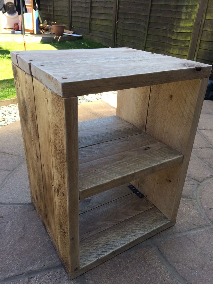 a wooden table sitting on top of a patio