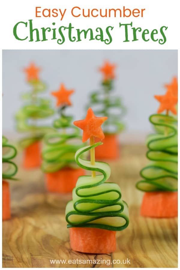 christmas tree cupcakes with green icing and orange stars on top, sitting on a wooden table