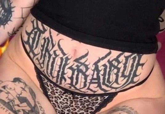 a person with tattoos on their stomach