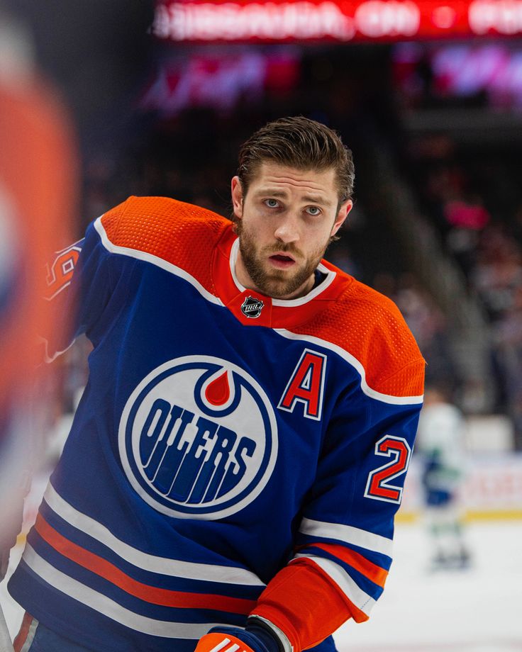 a hockey player with an orange and blue jersey