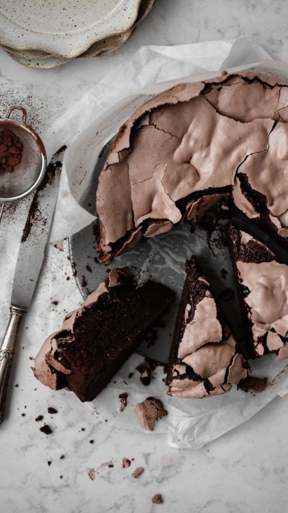 a chocolate cake is cut into pieces on a plate