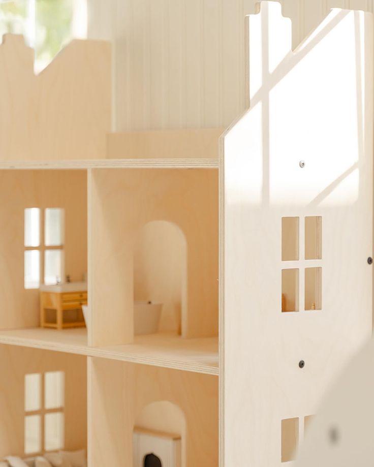 a doll house is shown with all the windows and doors open in front of it