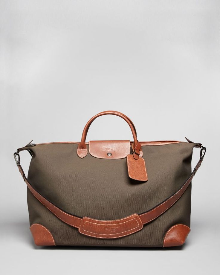 Longchamp Boxford Large Duffel Bag Brown Canvas Weekender Bag With Top Carry Handle, Designer Travel Satchel With Leather Handles, Classic Coated Canvas Shoulder Bag With Luggage Sleeve, Designer Travel Bag With Leather Handles For Everyday, Classic Travel Bag With Luggage Sleeve And Coated Canvas, Designer Satchel With Leather Handles For Travel, Classic Tote Luggage With Leather Trim, Classic Coated Canvas Travel Bag, Classic Duffle Bag With Luggage Sleeve In Coated Canvas