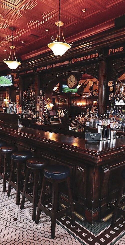 a bar with several stools in front of it