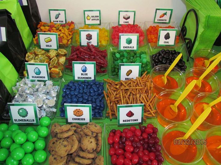 a table filled with lots of different types of candy and candies on top of plastic containers