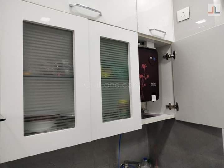 a bathroom with white cabinets and grey flooring is seen in this image from the inside