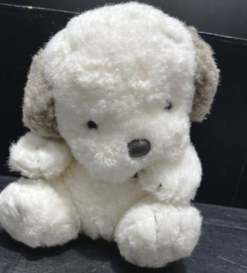 a white stuffed animal sitting on top of a table