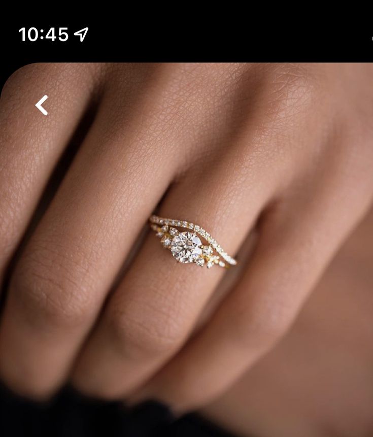 a woman's hand with three diamond rings on her left and the middle finger