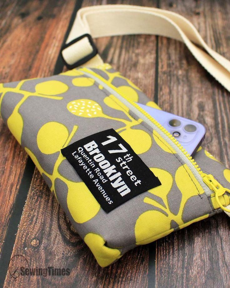 a cell phone case with a yellow and gray flower pattern on it sitting on a wooden table