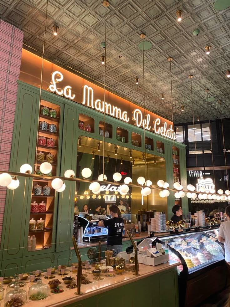 the interior of a deli restaurant with green cabinets and lights hanging from the ceiling