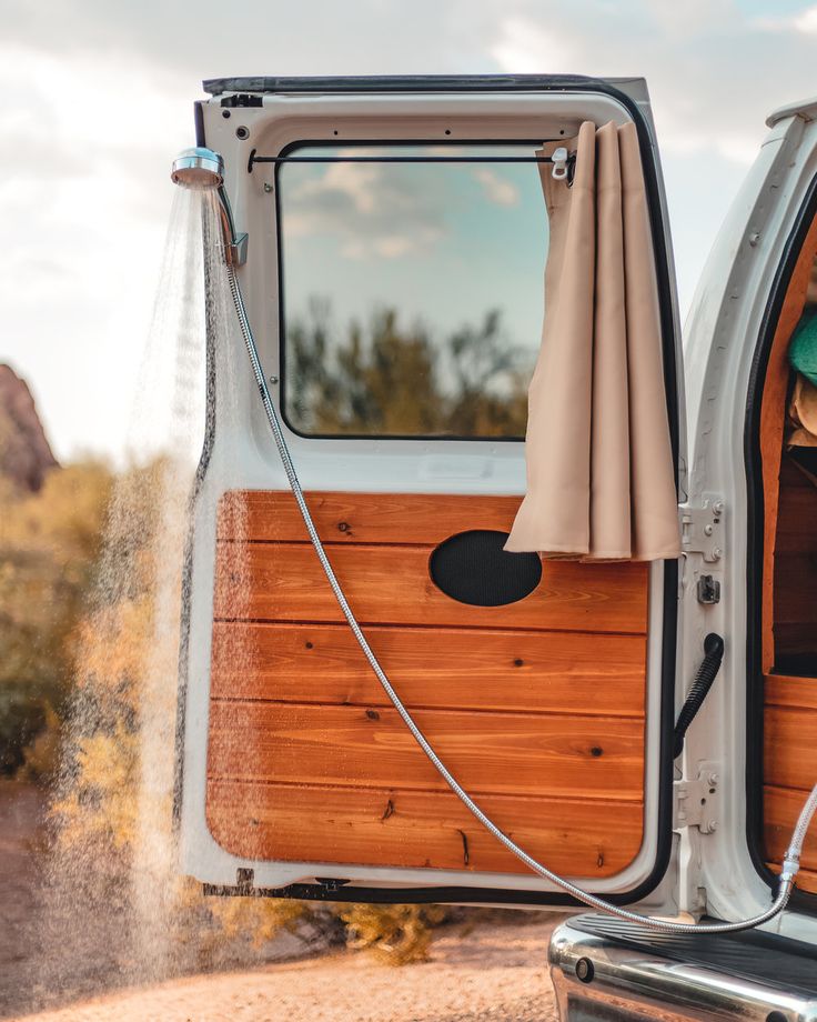 the back door of a van with an open window and wood paneling on it