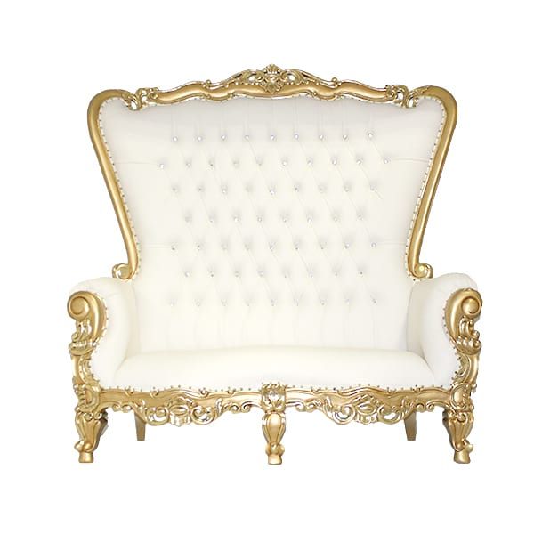 a white and gold couch with ornate detailing on the arm rests in front of a white background