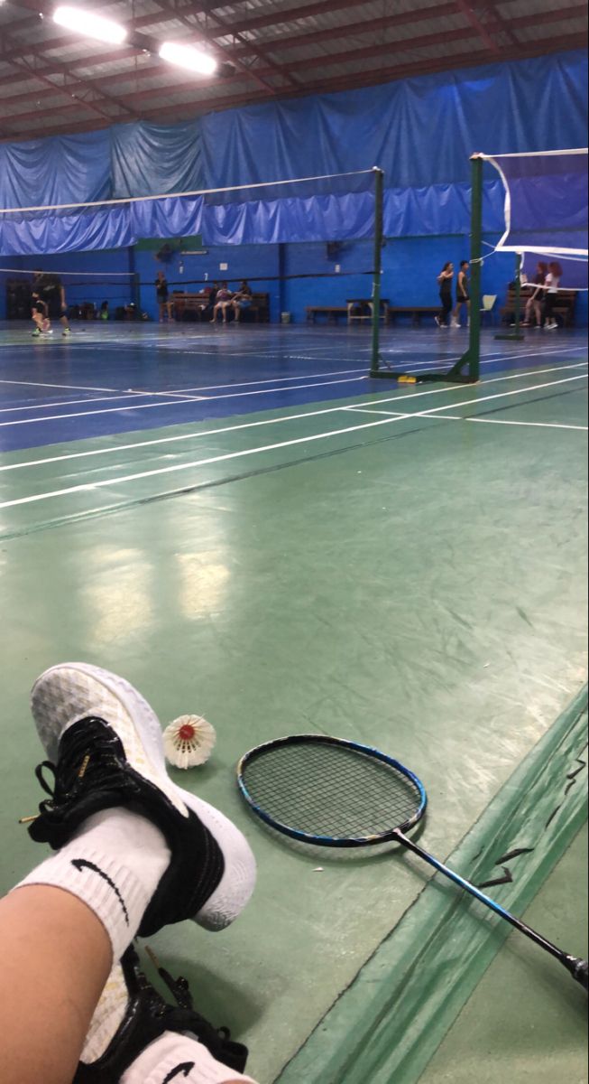 a tennis player's feet resting on the court