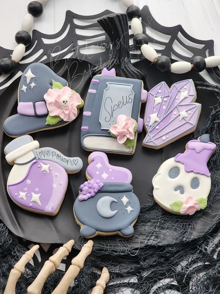 some decorated cookies are on a black plate