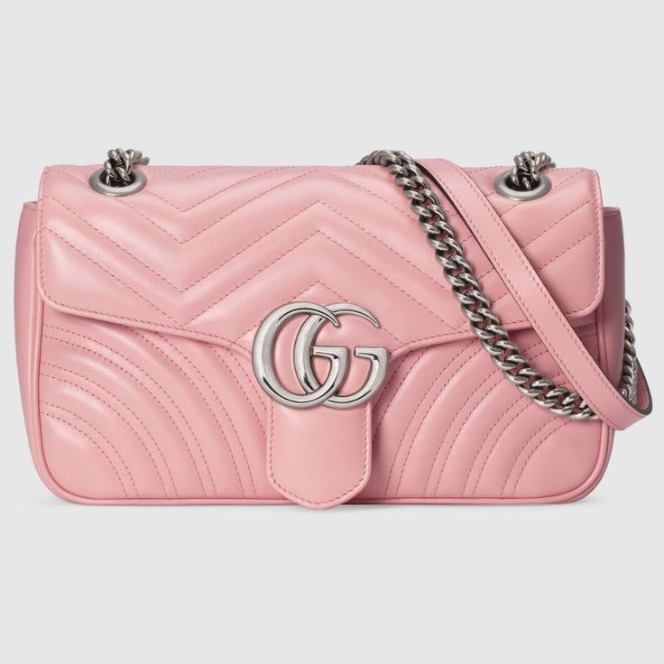 a pink handbag with a silver gg logo on the front and shoulder strap