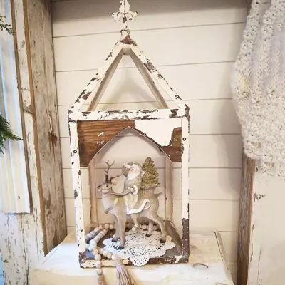 an old fashioned nativity scene is displayed on a shelf in the corner of a room