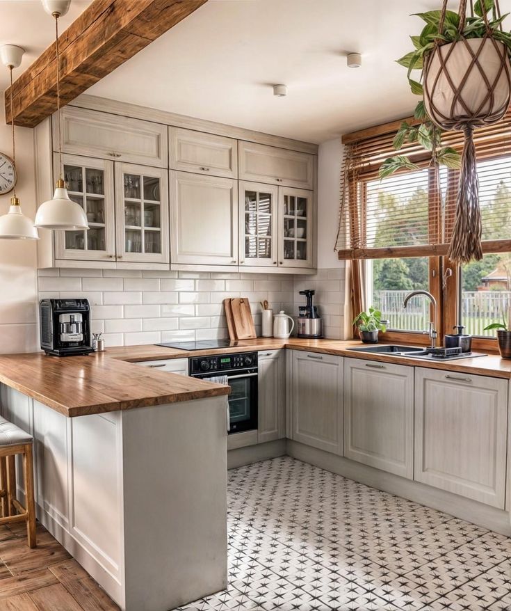 a kitchen with white cabinets and wooden counter tops next to a window that looks out onto the yard