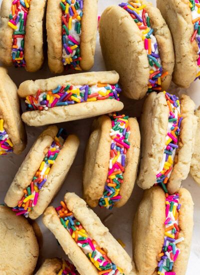 a pile of cookies with sprinkles and frosting