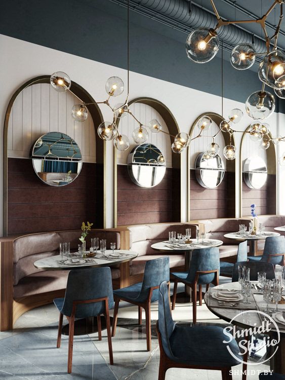 an empty restaurant with blue chairs and round mirrors