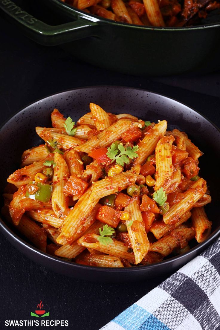 a bowl filled with pasta and sauce on top of a table