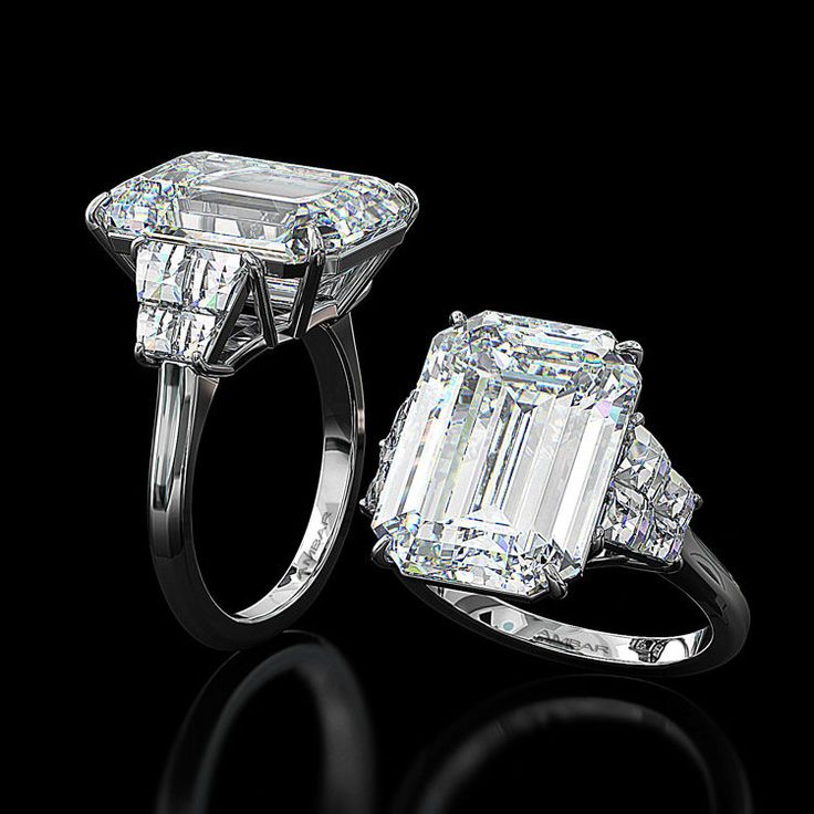 an emerald - cut diamond ring with two baguets