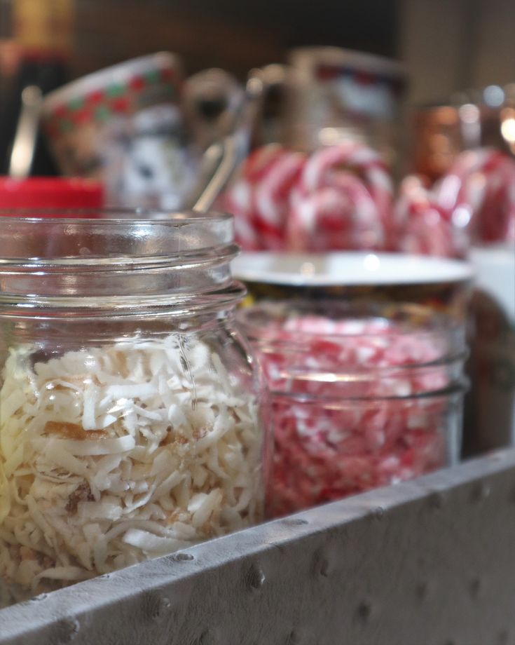 several jars filled with different types of food