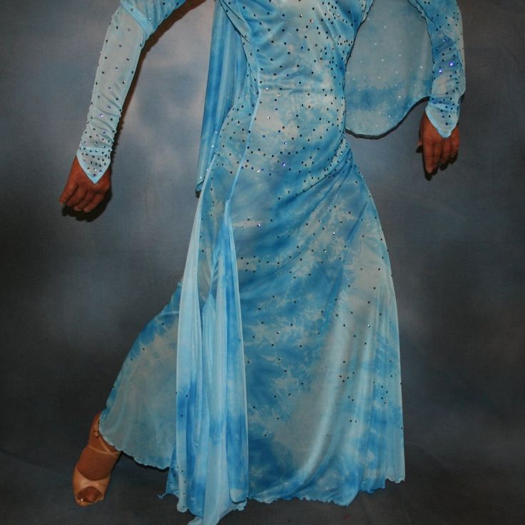 will fit size 3/4-9/10, stretchy Glimmer in this exquisite blue ballroom dress with long sleeves, designed with stunning printed semi sheer stretch and floaters. Instantly turn heads with the elegant Swarovski rhinestone work, highlighting shades of capri blue and aquamarine. You'll look like a princess as you gracefully glide across the dance floor with all the confidence and comfort you need for executing your ballroom dance moves. It's heaven-sent for that glamorous solo ballroom dance or the Blue Long Sleeve Gown With Fitted Bodice, Fitted Light Blue Long Sleeve Gown, Fitted Blue Ballroom Dress, Blue Stretch Dresses For Ballroom, Fitted Long Sleeve Ballroom Dress, Fitted Long Sleeve Dress For Ballroom, Blue Ballroom Dress, Blue Ballroom, Ballroom Dress