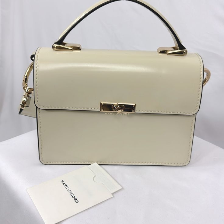 Removable Shoulder Strap Cream Nwot Top Handle 8.3” W X 2.6 In D X 6.3 In H Formal Cream Shoulder Bag With Branded Hardware, Cream Shoulder Bag With Branded Hardware For Formal Occasions, Modern Cream Shoulder Bag With Branded Hardware, Formal Cream Satchel With Branded Hardware, Evening Shoulder Bag In Beige With Branded Hardware, Beige Rectangular Flap Bag With Branded Hardware, Evening Bags With Branded Hardware In Cream, Cream Evening Bags With Branded Hardware, Beige Classic Flap Bag With Branded Hardware