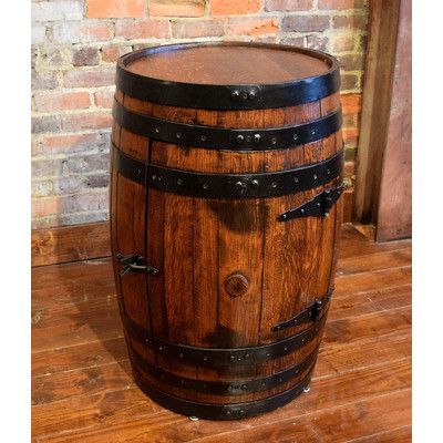 a wooden barrel sitting on top of a wooden floor