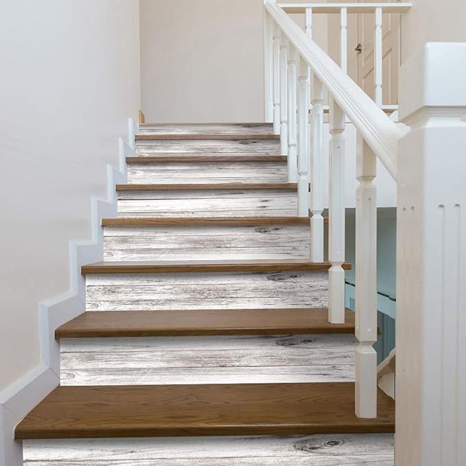 a set of wooden stairs leading up to a second floor room with white painted walls