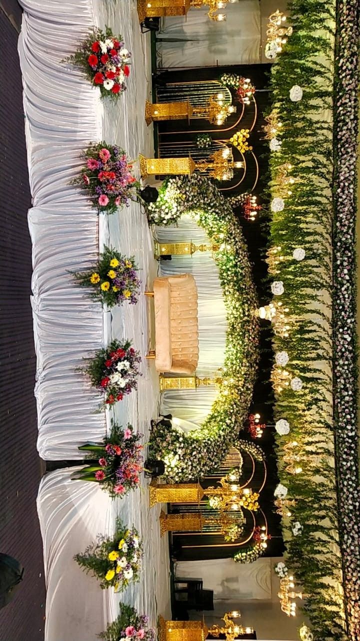 a long table with flowers and candles on it