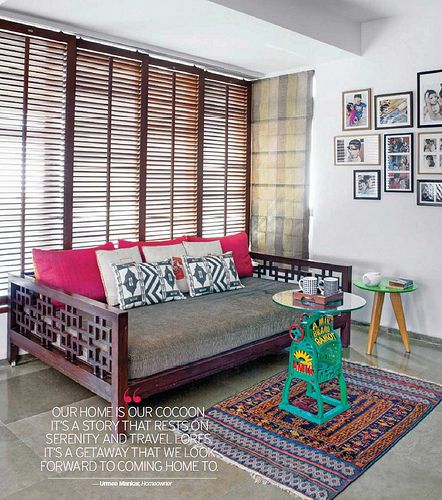 a living room filled with furniture and pictures on the wall