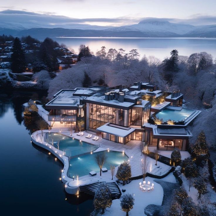 an aerial view of a house with a swimming pool and hot tub in the foreground