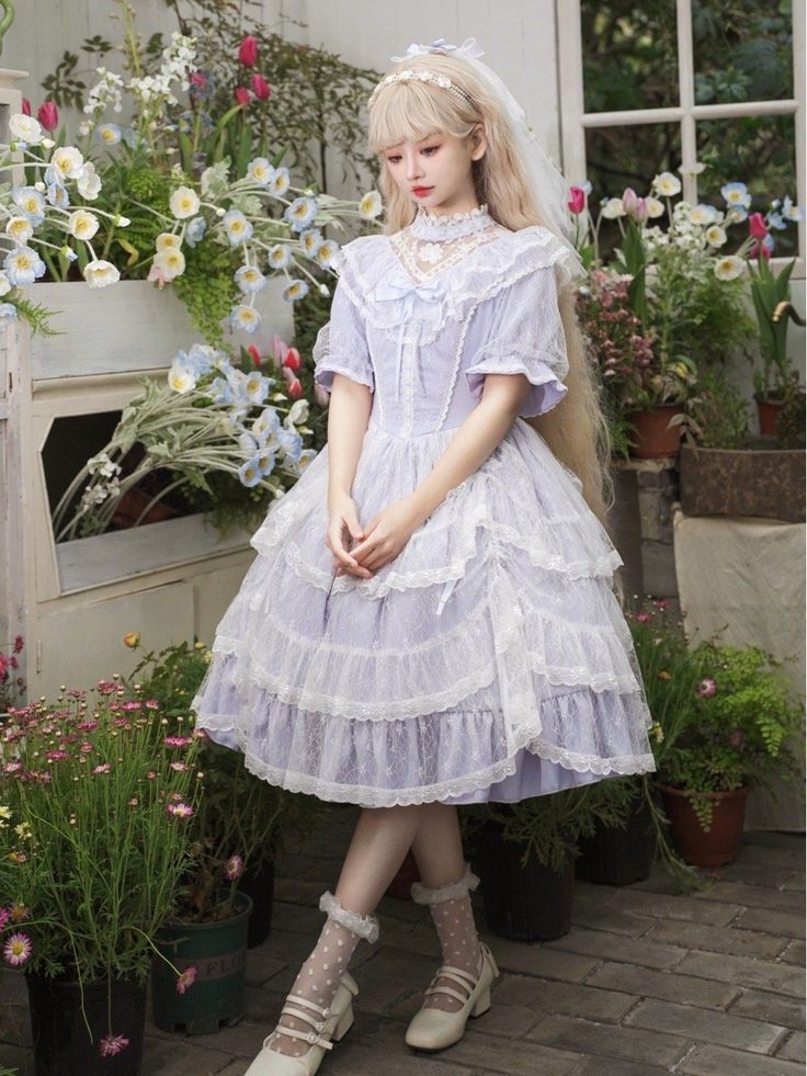 This elegant and enchanting one-piece Lolita dress features a beautiful light purple Edward neck design and a delicate white lace overlay skirt. The combination of the soft purple color and the intricate lace detail creates a classic and timeless look that is perfect for any Lolita fashion enthusiast. This dress is a must-have for anyone looking to add a touch of ethereal beauty to their wardrobe.  This price includes an OP only, others are not included.   	 		 			Size 			S 			M 			L 			XL Elegant Lavender Dress With Lace Trim, Purple Lace Patchwork Summer Dress, Summer Purple Dresses With Lace Patchwork, Summer Purple Lace Patchwork Dresses, Purple Lace Dress With Ruffles, Purple Lace Dresses With Ruffles, Lavender Lace Dress For Summer, Summer Lavender Lace Dress, Feminine Purple Lace Dress