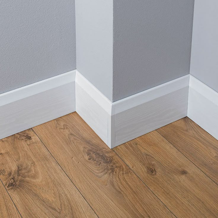 the corner of a room with wood flooring