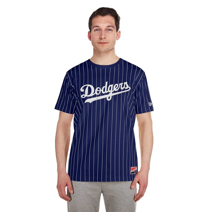 Get that clean, pinstriped look in a comfy tee with the New Era Los Angeles Dodgers Throwback Pinstripe Tee. Cheer on your favorite team in style in this shirt. From front to back, represent your team with pride. This classic tee features their logo on the lower right-hand side. Officially licensed. Ribbed collar. Fit: Regular. Fabric: 63% Cotton, 37% Polyester. Chevron stitched applique team wordmark at the front. Screen-printed team logo at the rear. Chevron Stitch, Soccer Shop, White Kicks, Kids Sale, Los Angeles Dodgers, Short Jacket, Comfy Tees, Dress With Boots, Favorite Team