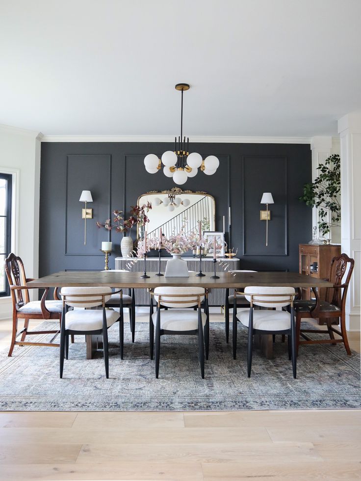 a dining room table with chairs and a chandelier