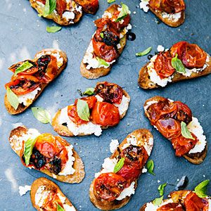 toasted bread topped with tomatoes, cheese and basil