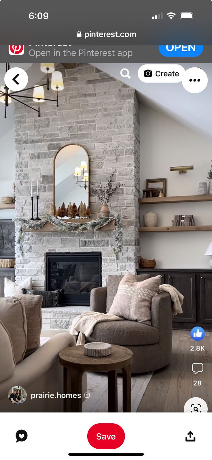 a living room filled with furniture and a fire place in front of a stone fireplace