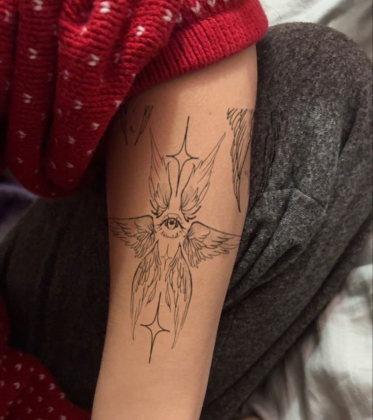 a woman's arm with a tattoo on it that has an image of a bird