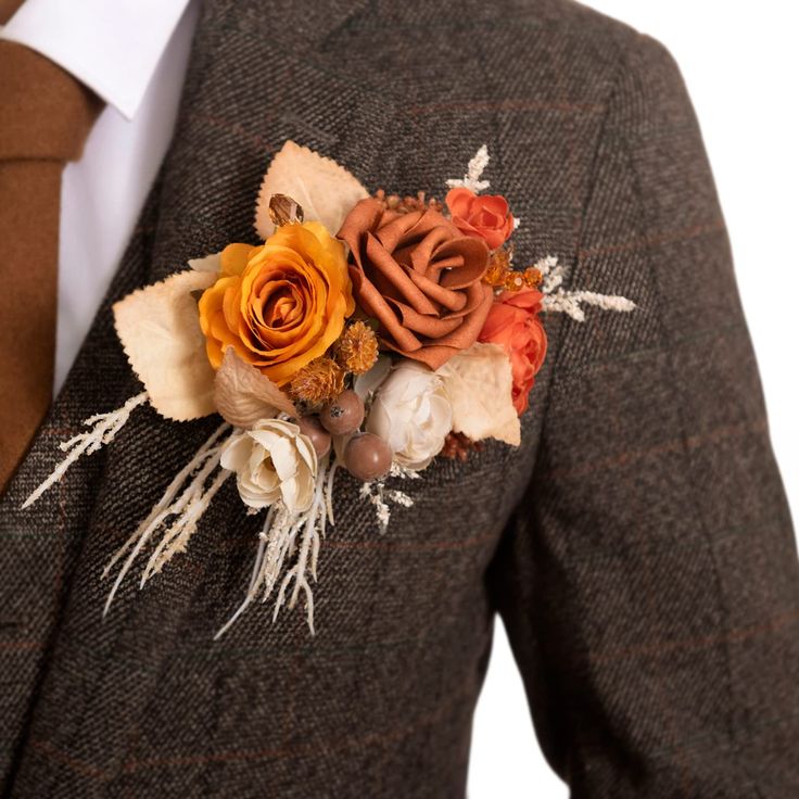 a man wearing a suit and tie with flowers on his lapel flower is shown